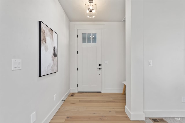 entryway featuring baseboards, visible vents, and light wood-style floors