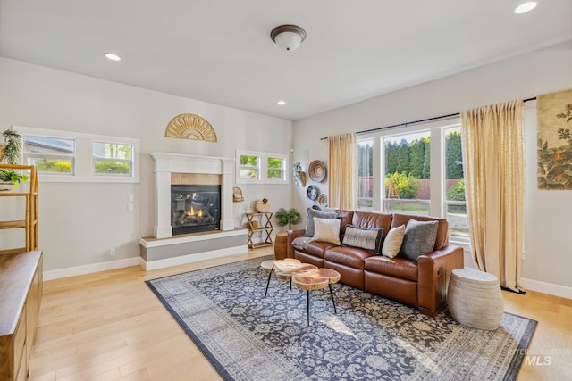 327 E Rockingham Dr, Eagle, ID 83616 - living room featuring light wood-type flooring, a glass covered fireplace, baseboards, and recessed lighting