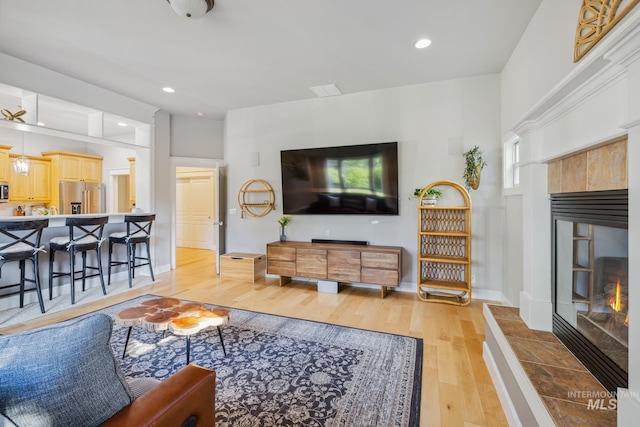 327 E Rockingham Dr, Eagle, ID 83616 - living area with a fireplace, light wood-style flooring, baseboards, and recessed lighting