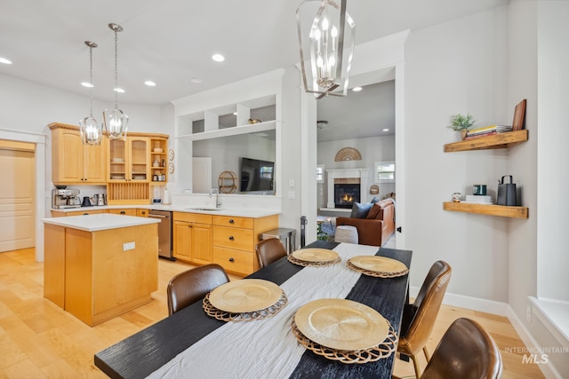 327 E Rockingham Dr, Eagle, ID 83616 - kitchen featuring open shelves, a chandelier, stainless steel dishwasher, light countertops, and a center island