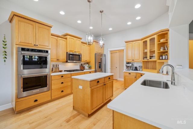 327 E Rockingham Dr, Eagle, ID 83616 - kitchen featuring stainless steel appliances, a sink, a kitchen island, glass insert cabinets, and light countertops