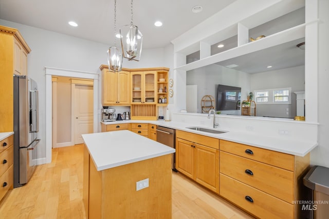 327 E Rockingham Dr, Eagle, ID 83616 - kitchen with stainless steel appliances, a sink, a kitchen island, light wood-style floors, and recessed lighting