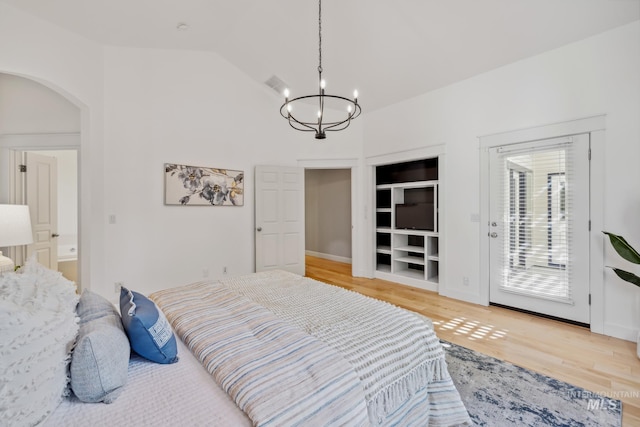 327 E Rockingham Dr, Eagle, ID 83616 - bedroom with a chandelier, access to outside, arched walkways, light wood-type flooring, and high vaulted ceiling