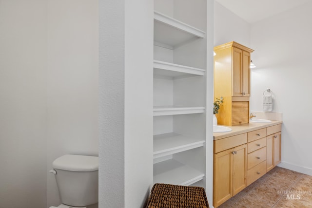 327 E Rockingham Dr, Eagle, ID 83616 - bathroom with double vanity, toilet, built in shelves, and tile patterned floors