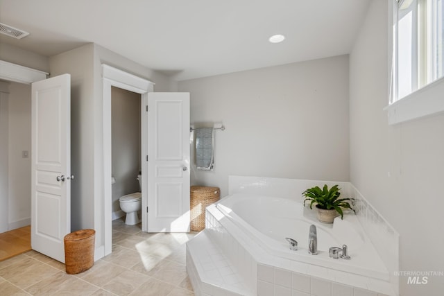 327 E Rockingham Dr, Eagle, ID 83616 - bathroom with toilet, a garden tub, tile patterned flooring, and recessed lighting