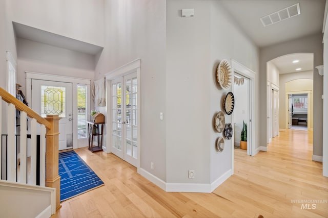 327 E Rockingham Dr, Eagle, ID 83616 - entryway with french doors, wood finished floors, arched walkways, baseboards, and a towering ceiling