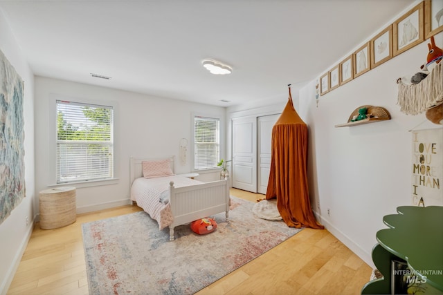327 E Rockingham Dr, Eagle, ID 83616 - bedroom featuring multiple windows, wood finished floors, and baseboards