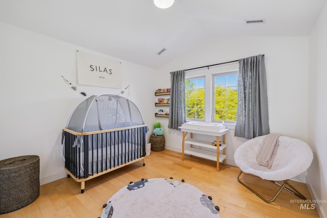 327 E Rockingham Dr, Eagle, ID 83616 - bedroom featuring vaulted ceiling, wood finished floors, and baseboards