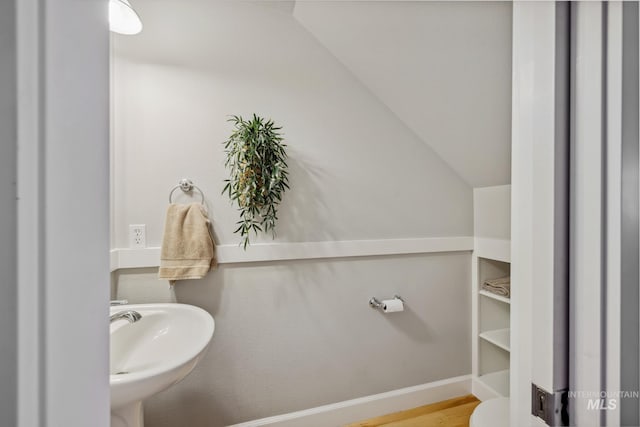 327 E Rockingham Dr, Eagle, ID 83616 - bathroom featuring a sink, vaulted ceiling, wood finished floors, and baseboards