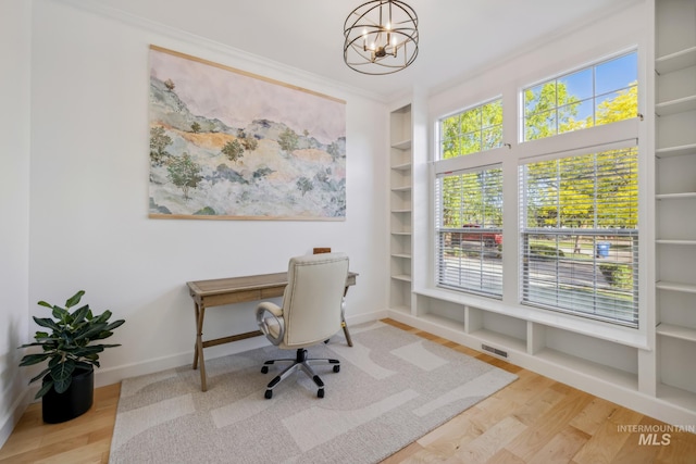 327 E Rockingham Dr, Eagle, ID 83616 - office space with a chandelier, wood finished floors, built in shelves, baseboards, and ornamental molding