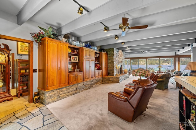 4076 Warren Wagon Rd, Mccall, ID 83638 - living area with light colored carpet, beam ceiling, and a ceiling fan