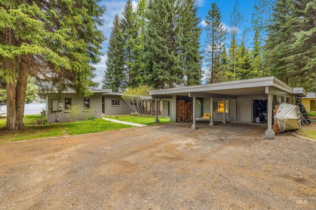 4076 Warren Wagon Rd, Mccall, ID 83638 - view of front of house with driveway, a front yard, and a carport