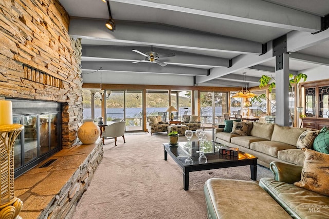 4076 Warren Wagon Rd, Mccall, ID 83638 - carpeted living room featuring a fireplace, a water view, ceiling fan, and healthy amount of natural light