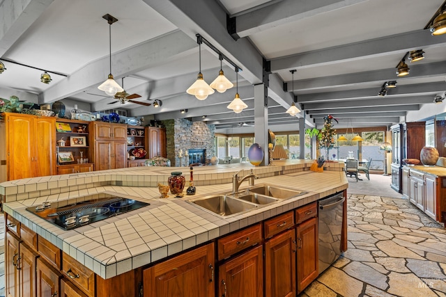 4076 Warren Wagon Rd, Mccall, ID 83638 - kitchen with black electric cooktop, stone flooring, beamed ceiling, stainless steel dishwasher, and ceiling fan