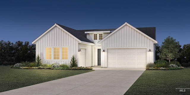 modern inspired farmhouse with a garage, driveway, a front lawn, and board and batten siding