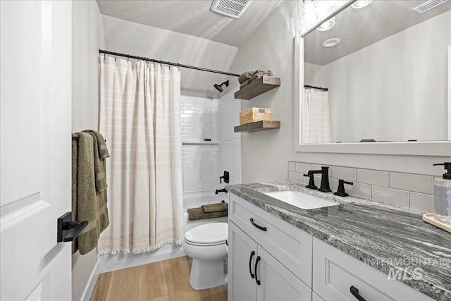 full bathroom with shower / bathtub combination with curtain, vanity, backsplash, toilet, and hardwood / wood-style flooring