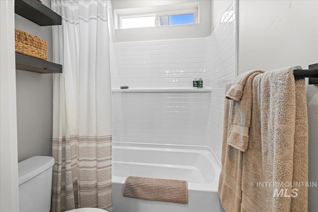 bathroom with toilet and shower / bathtub combination with curtain