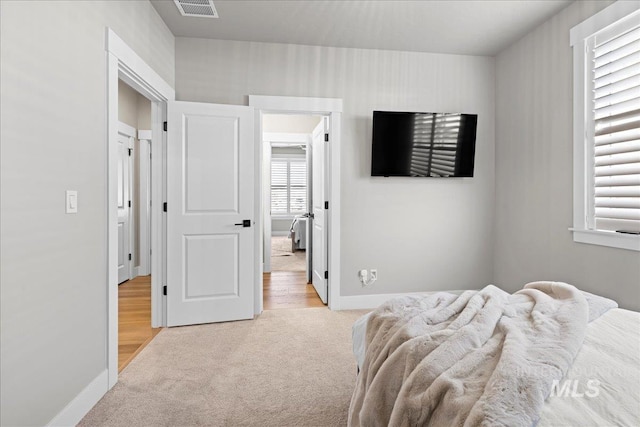 bedroom with light colored carpet