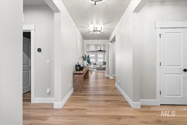 corridor with light hardwood / wood-style flooring