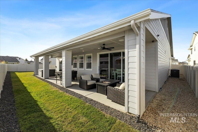 rear view of property with ceiling fan, a patio area, outdoor lounge area, a lawn, and central AC