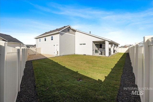 rear view of house with a yard