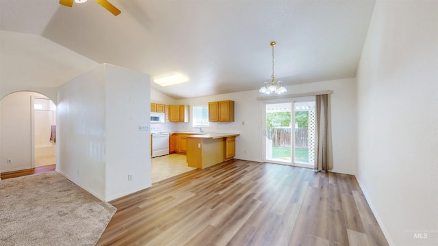 278 Trotter Dr, Twin Falls, ID 83301 - kitchen with white appliances, light countertops, lofted ceiling, light wood-type flooring, and a chandelier