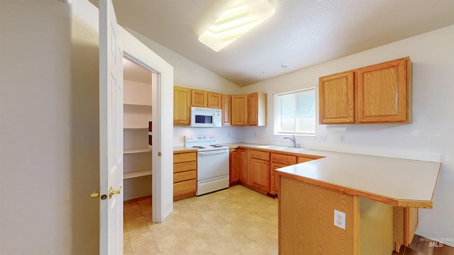 278 Trotter Dr, Twin Falls, ID 83301 - kitchen featuring white appliances, a peninsula, vaulted ceiling, light countertops, and a breakfast bar