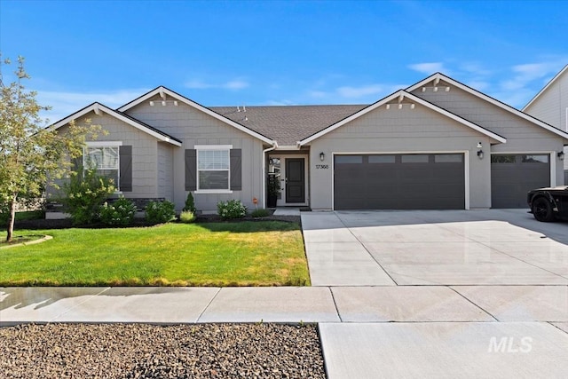 ranch-style home with an attached garage, a front yard, and concrete driveway