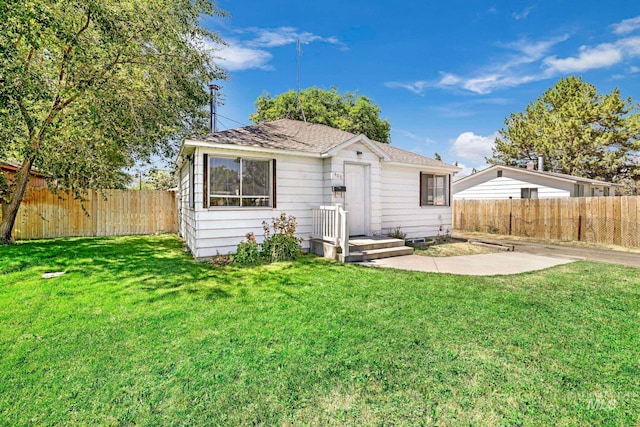 rear view of house featuring a lawn