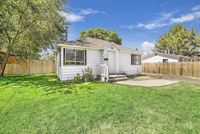 rear view of property with a lawn, a patio area, and a fenced backyard