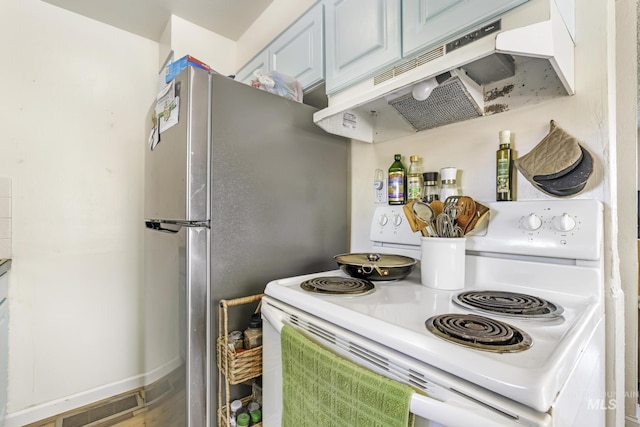 kitchen featuring freestanding refrigerator, white electric stove, and under cabinet range hood