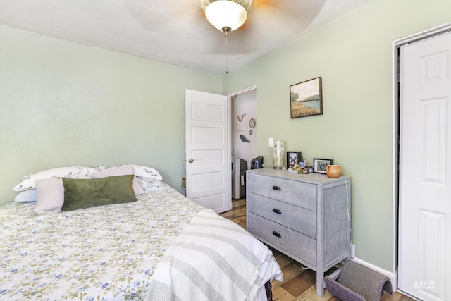 bedroom featuring ceiling fan, wood finished floors, and baseboards