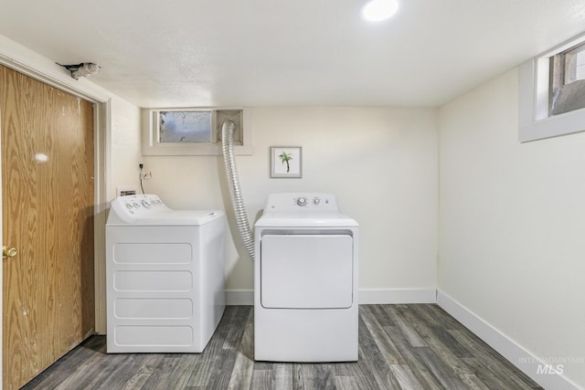 washroom featuring independent washer and dryer, wood finished floors, and baseboards