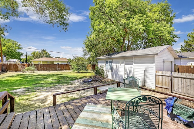 wooden terrace with a fenced backyard, a yard, and an outdoor structure