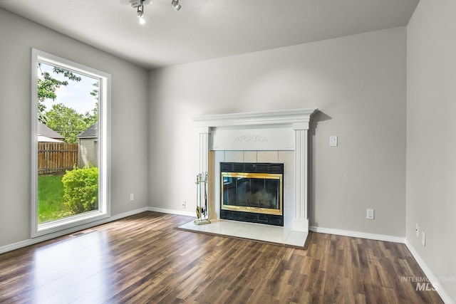 2943 S Zach Pl, Boise, ID 83706 - unfurnished living room featuring wood finished floors, a fireplace, and baseboards
