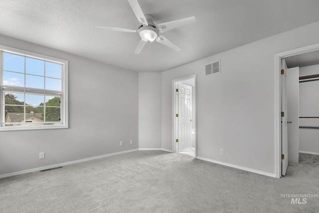 2943 S Zach Pl, Boise, ID 83706 - unfurnished bedroom with a walk in closet, carpet flooring, baseboards, connected bathroom, and ceiling fan