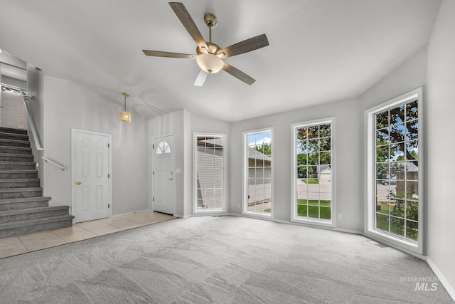 2943 S Zach Pl, Boise, ID 83706 - unfurnished living room featuring carpet, ceiling fan, stairs, baseboards, and vaulted ceiling