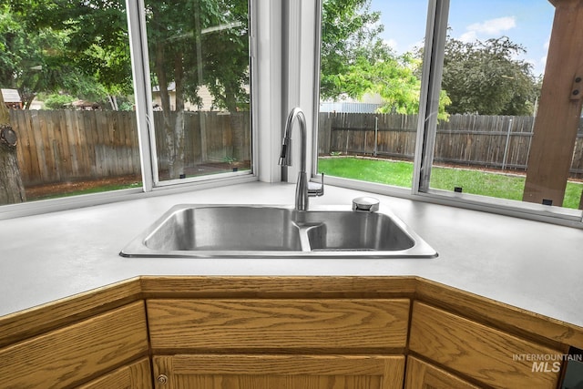 2943 S Zach Pl, Boise, ID 83706 - kitchen view of a sink, light countertops, and brown cabinetry