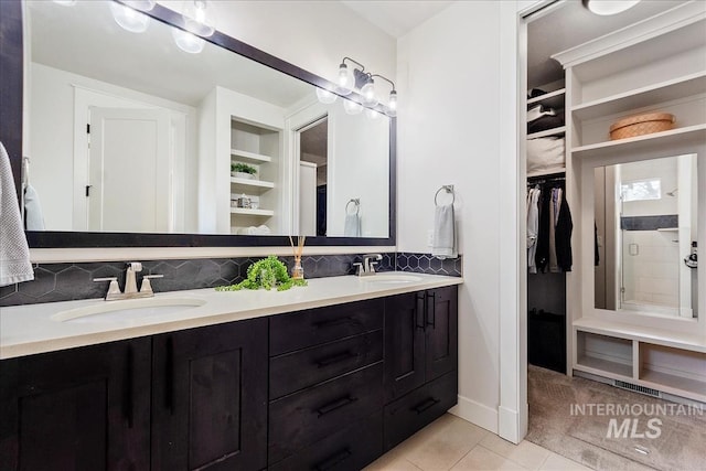 3268 S Sedgebrook Ln, Eagle, ID 83616 - full bath featuring a spacious closet, tile patterned floors, a sink, and decorative backsplash