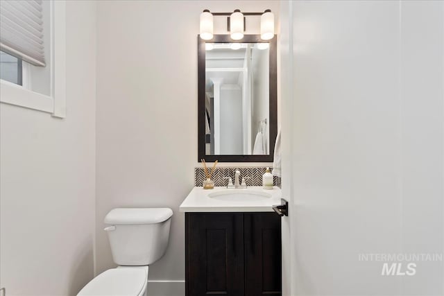 3268 S Sedgebrook Ln, Eagle, ID 83616 - bathroom with toilet, vanity, and decorative backsplash