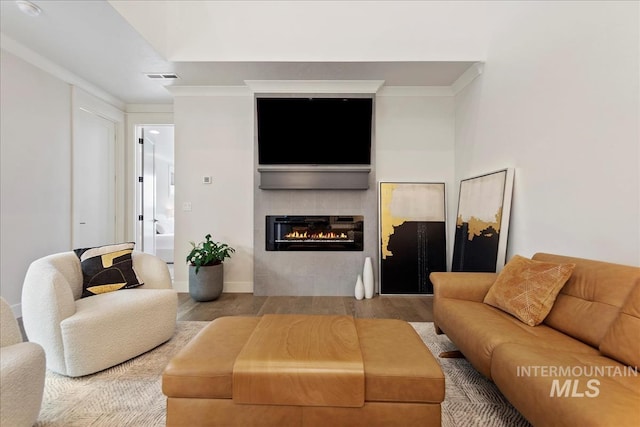 3268 S Sedgebrook Ln, Eagle, ID 83616 - living room with a tile fireplace, wood finished floors, baseboards, visible vents, and ornamental molding