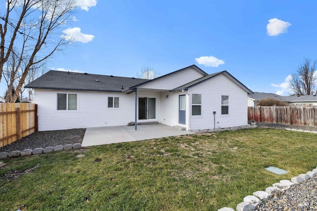 rear view of property with a patio, a yard, and a fenced backyard