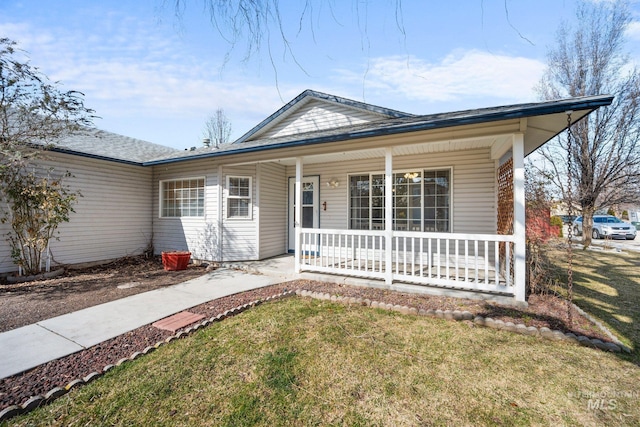 view of front of property with covered porch and a front lawn