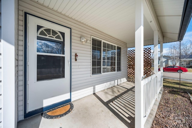 view of exterior entry with a porch