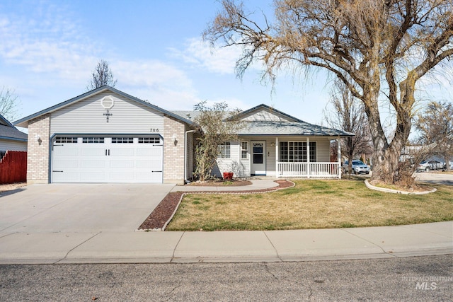 view of front of home featuring an attached garage, covered porch, brick siding, driveway, and a front lawn