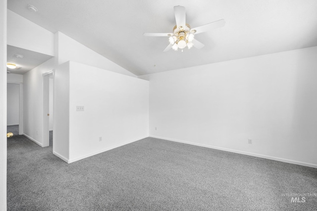 unfurnished room with ceiling fan, baseboards, vaulted ceiling, and carpet flooring