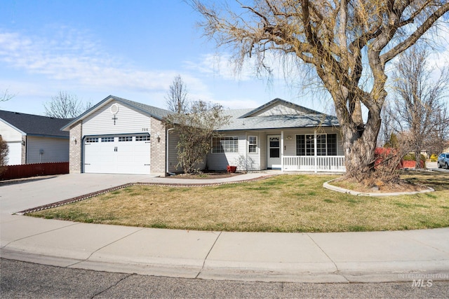 view of front facade with a porch, a garage, brick siding, concrete driveway, and a front yard