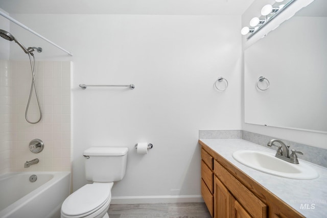 bathroom featuring toilet, washtub / shower combination, baseboards, and vanity