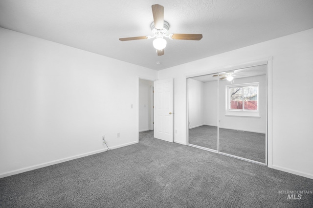 unfurnished bedroom featuring ceiling fan, a closet, carpet flooring, and baseboards