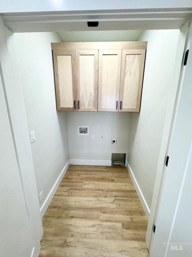 laundry room with cabinets, electric dryer hookup, washer hookup, and light wood-type flooring